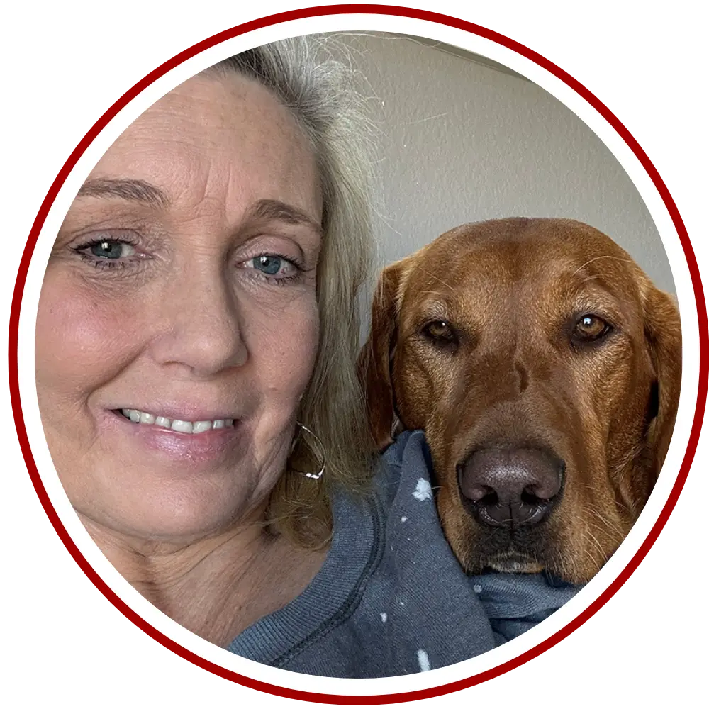 author photo of kerri pogar with her red fox lab ginger